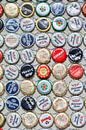 Bonte verzameling beer bottle caps geplakt op een muur van Tony Vingerhoets thumbnail