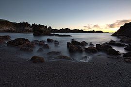 Als de zee tot rust komt, zonsondergang en de rustige lavakust