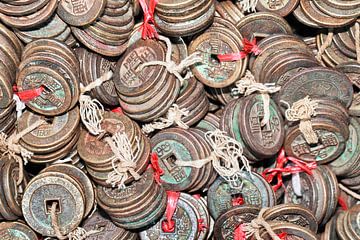 Tied antique Chinese coins on a Chinese flea market by Tony Vingerhoets