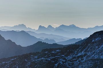 Silhouettes in layers of alpine and Dolomite mountains at sunrise