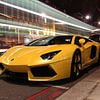 Yellow Lambo supercar in London with passing double-decker by Atelier Liesjes