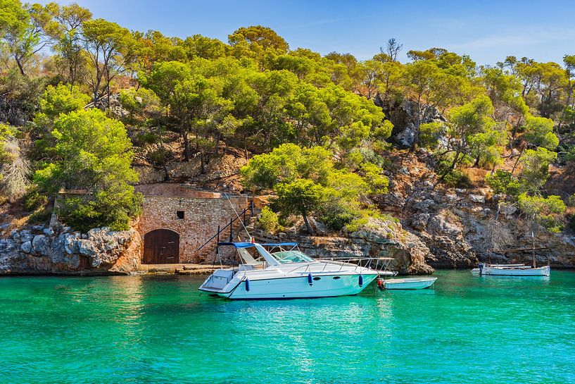Idyllic view of anchoring yacht in beautiful bay on Majorca island, Spain by Alex Winter