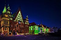 View of a square with brightly coloured buildings at night