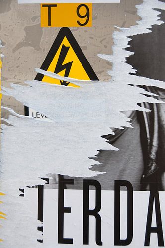 leaflets on a wall partly peeled off