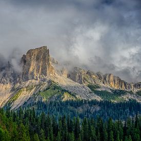 A play between the sun and the clouds, above the mountains of the Dolomites by Leon Okkenburg