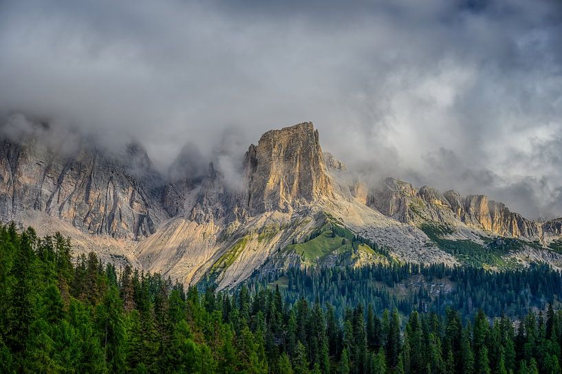A play between the sun and the clouds, above the mountains of the Dolomites by Leon Okkenburg