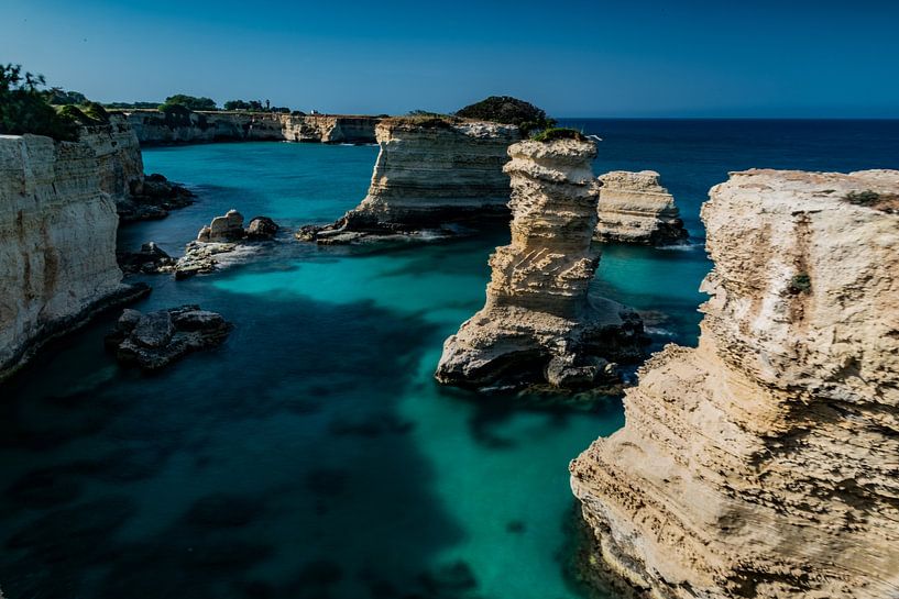 Limestone rocks in sea by Alex Neumayer