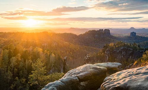 This photo was taken in Saxon Switzerland or the Elbe Sandstone Mountains.  It shows the sunset as seen from the Carola Rock.
