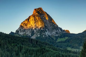 The Grosser and Kleiner Mythen mountains of Schwyz in central Switzerland glow with alpenglow on a beautiful autumn day.