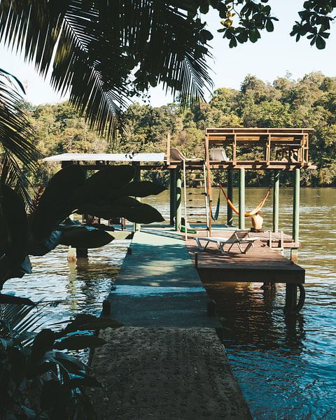 Jetty in the river Rio Dulce in front of the Round House Hostel in Guetamala. by Michiel Dros