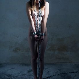 Naked woman restrained with heavy bondage BDSM chains by Photostudioholland