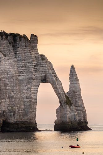The typical chalk cliffs of Etretat (France) at sunset.