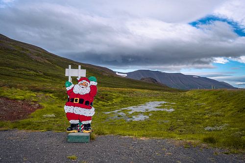 Santa Claus with Icelandic landscape and alpine mountain peaks w