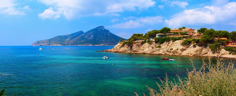 Sunny day on the rocky beach with blue water by Yevgen Belich