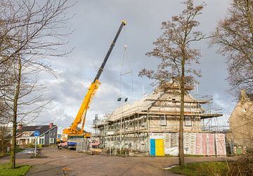 House building at construction site van Micha Klootwijk