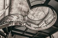 Swinging round industrial stairs in old building, in vintage colours