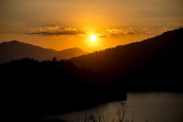 Vietnamese Sunset over mountains and lake by Michiel Ton