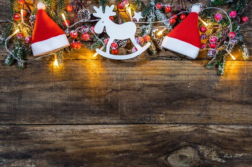 Traditional Christmas decoration with santa cap, reindeer, fir branches, red berries, pine cones by Alex Winter