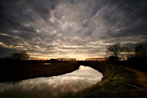 Fluss mit Wolkendecke bei Sonnenuntergang