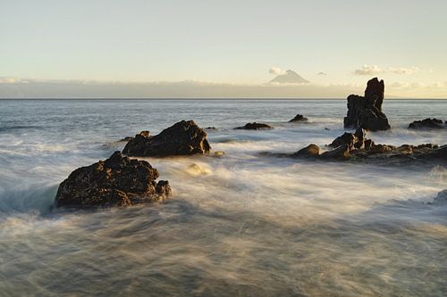 Wild coast with mountain silhouette in the evening light