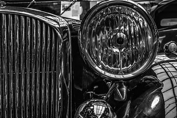 The left headlight of a vintage car in black and white. by Nicolaas Digi Art