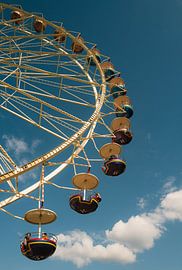 Ferris wheel against a blue sky by Olli Lehne