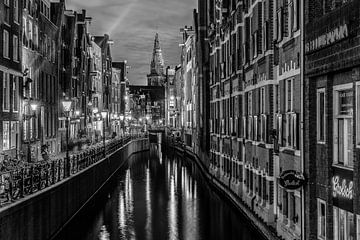 Amsterdam Damrak canal at night in Black and White by Mario Calma
