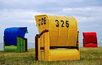 Red, blue and yellow beach chairs on the German Wadden Sea. by Alice Berkien-van Mil
