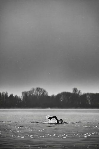Open water swimmer in winter, black and white by Sander de Vries