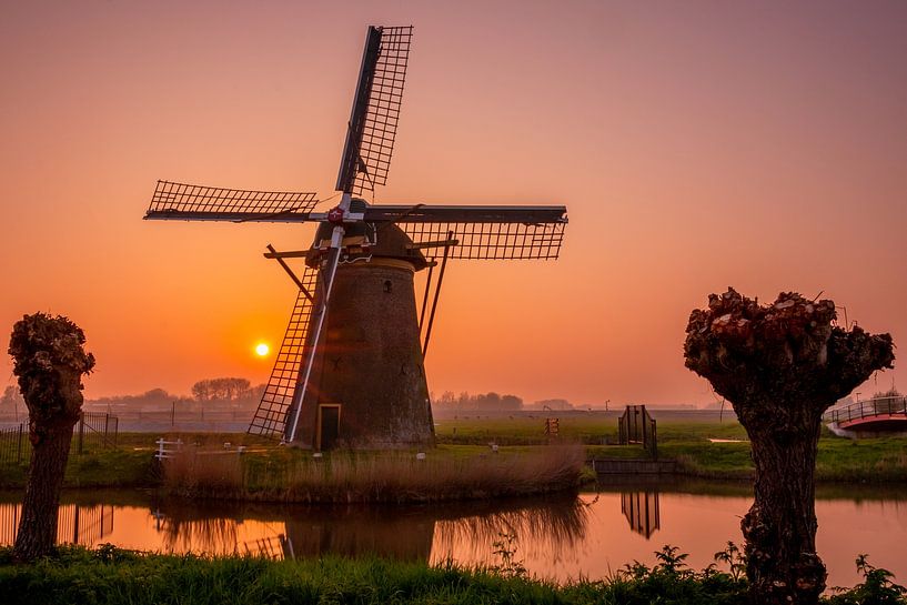 Windmill de stevenshofjesmolen during sunset by John Ouds