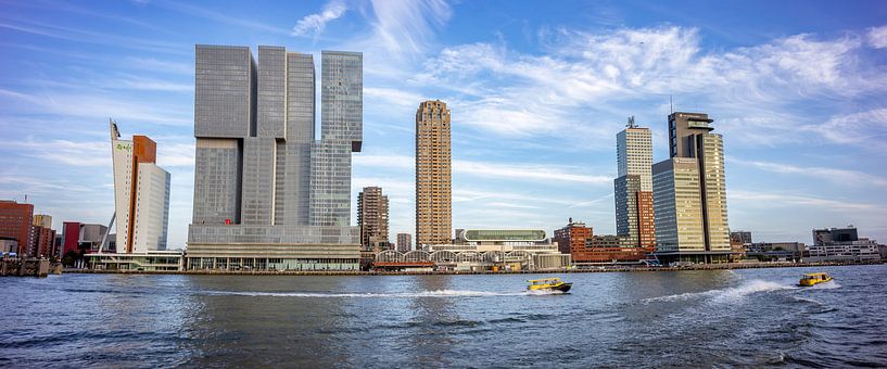 Water taxis skim past Rotterdam skyline by Maarten Zeehandelaar