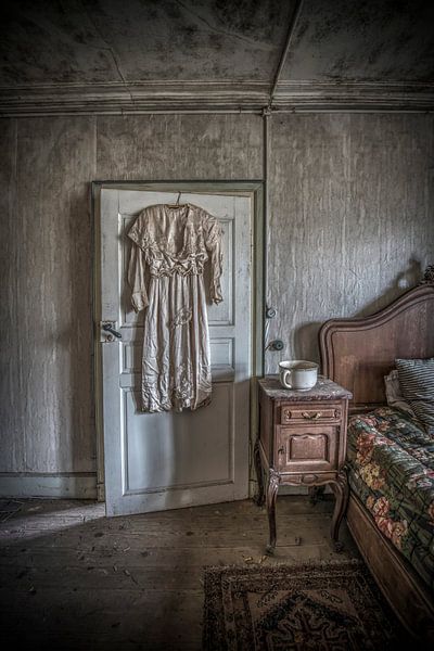 Dress at door of bedroom in abandoned farmhouse by Gerben van Buiten