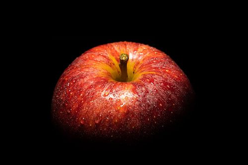 Red apple against a black background