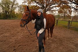 Training with the bay Oldenburg mare on a riding arena