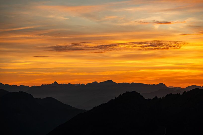 glowing red sky at sunset over the Allgäu alps by Leo Schindzielorz