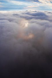 Flying above the glowing clouds, a symbol of the flight of a dream, a photo from a paraglider. by Michael Semenov