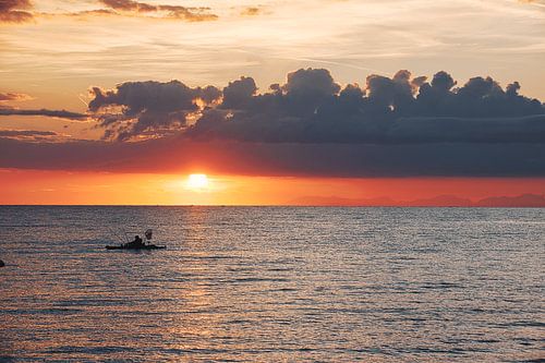 Romantic sunrise with small fishing boat