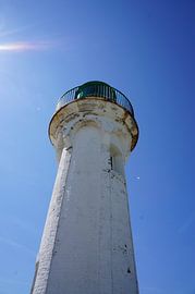 white lighthouse against blue sky in Normandy France by Sandra van der Burg