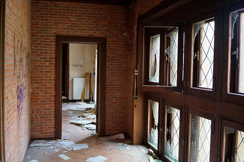 Hallway with windows in a Belgian dilapidated urbex chateau