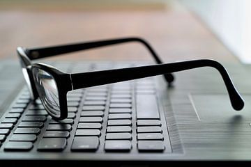 Glasses on a keyboard by Heiko Kueverling