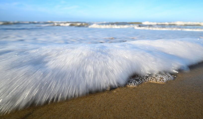 Golf rolling on the beach in close-up by Michel Knikker