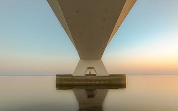 Zeeland bridge during serene sunset by Sander Hupkes