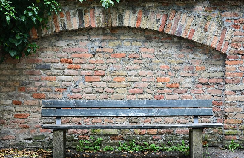 An old wooden bench in front of an old wall by Ulrike Leone