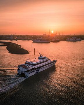 Speedboat departs from Harlingen at sunset by Ewold Kooistra