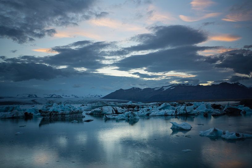 Iceland - Reflecting clouds in glacier lagoon between huge ice blocks by adventure-photos