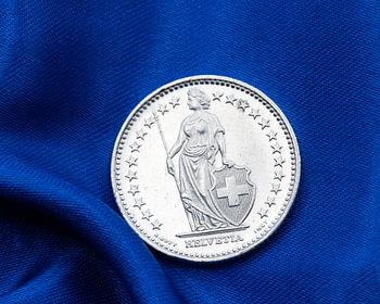 High-quality photo of a Swiss franc coin – linking Switzerland with the colours of the European Union