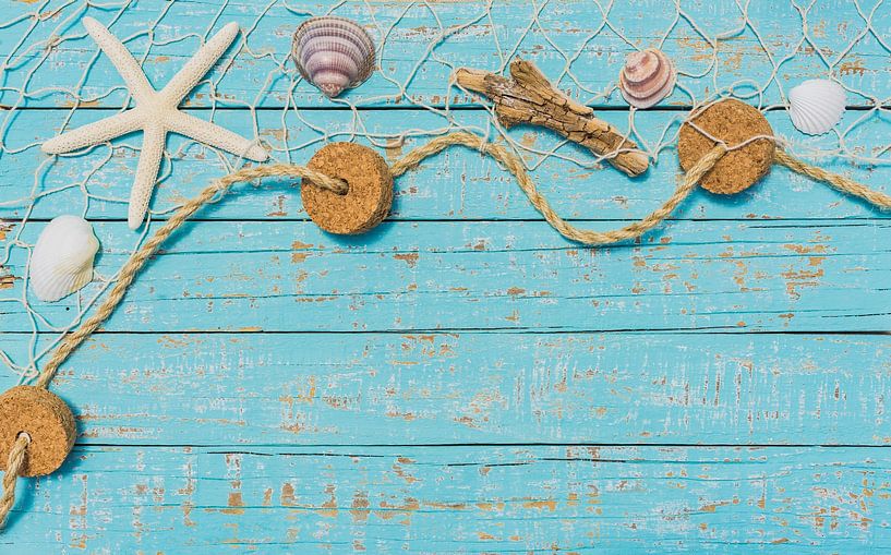 Starfish and Seashells in fishing net on turquoise wooden background by Alex Winter
