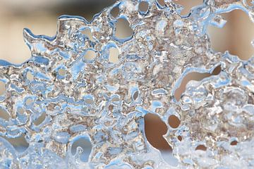 Ice, created by frozen water on snow by Margot van den Berg
