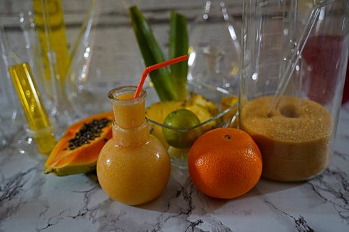tropical cocktail with pineapple-lime-papaya-orange.