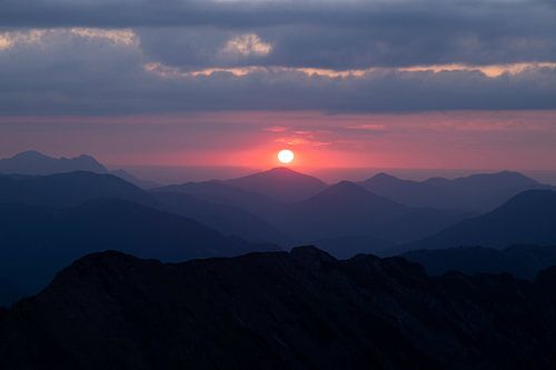 Pink sunset seen from mountain top in the Alps
